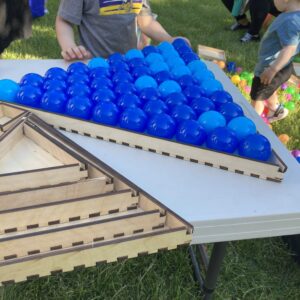 a large wooden triangle frame, filled with blue spheres