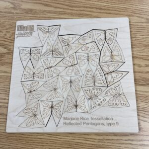 A wooden puzzle frame filled with natural-toned pentagons, each engraved with a half-butterfly.