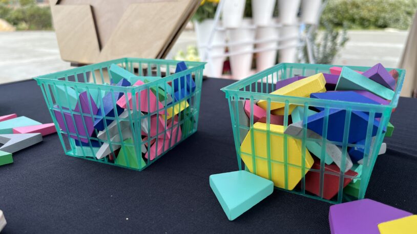A close-up photo of two berry baskets filled with 21st century pattern blocks.